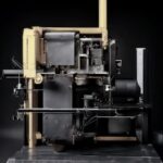 craiyon_214143_photo_of_a_metallic__square_machine_with_large_pipes_standing_alone__black_sludge_bei